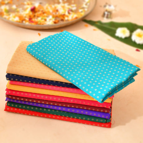 Stack of unstitched floral multicolor blouse pieces in vibrant teal orange and red for saree pooja and housewarming gifts