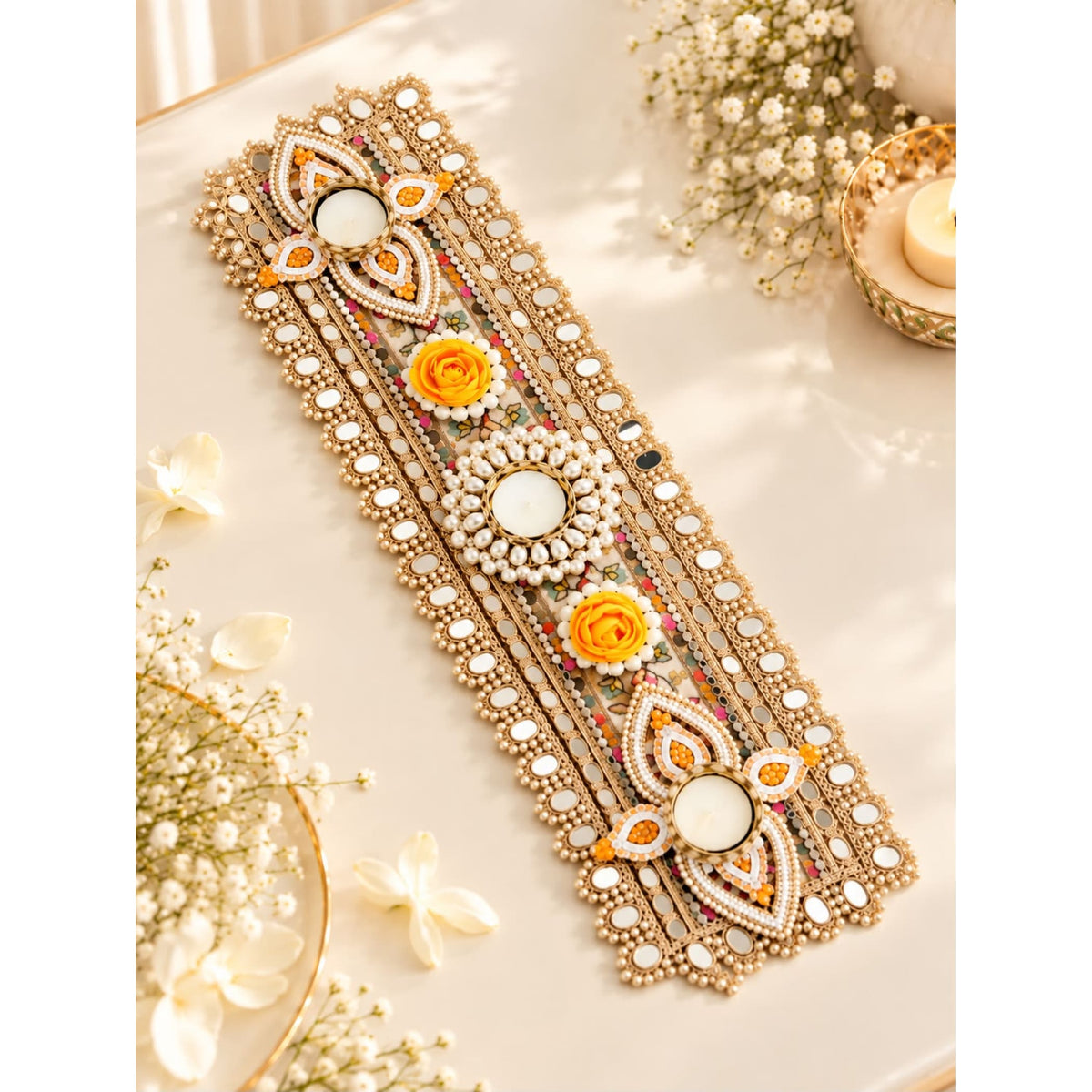 Gold-toned decorative mirror bracelet with intricate beaded patterns and orange white floral motifs for festive décor