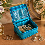 Vibrant turquoise velvet jewelry box with clear plastic window and zipper closure for travel and gifting organizer