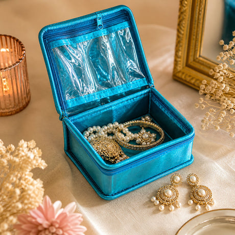Vibrant turquoise satin jewelry box with clear plastic insert and zipper closure for organizing Indian wedding favors