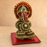 A vibrant beaded ganesh figurine supari with red trunk and golden accents for hindu wedding and pooja decor