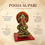 Ganesh designer supari features a golden and red beaded ganesha figurine with green white and gold embellishments for pooja