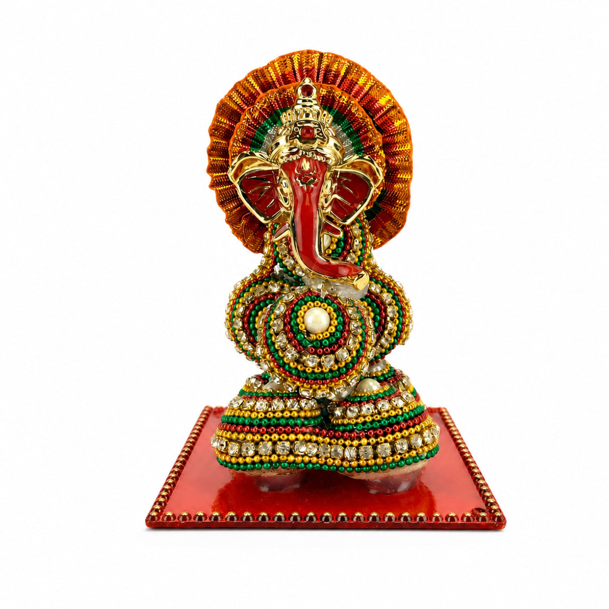 A vibrant ganesh designer supari with red trunk, golden accents, and green gold white beads on ornate red base for pooja
