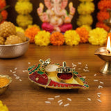 A vibrant gold-toned and red enamel diya tray with intricate green accents for Ganesh Shankh Haldi Kumkum holder