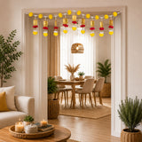 Door toran hanging bandarwal with golden lanterns red and yellow pompoms for home pooja decor and diwali celebration