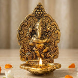Golden brass ganesha oil lamp diya with intricate carvings and lit flame for puja diwali temple decor and gifts
