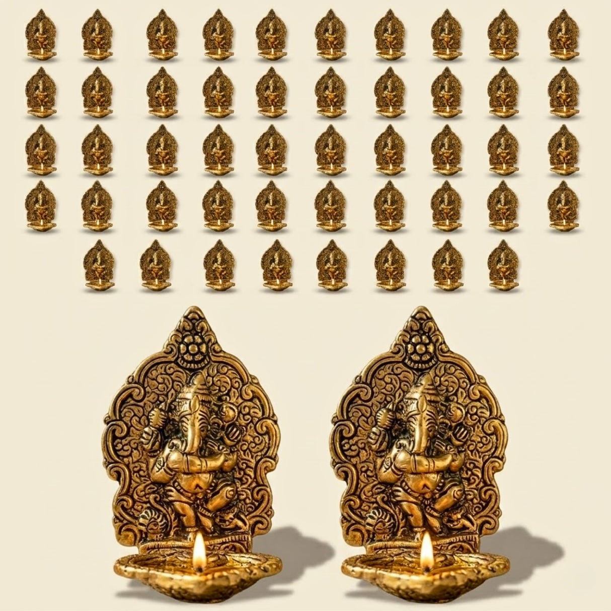 Golden brass ganesha oil lamps with intricate carvings and lit candles for puja and diwali home decor