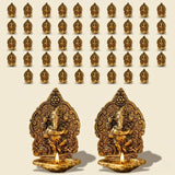 Golden brass ganesha oil lamps with intricate carvings and lit candles for puja and diwali home decor
