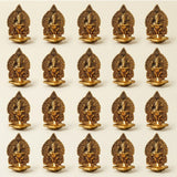 Golden brass ganesha diya oil lamp with intricate carvings and small flame for puja and diwali home decor
