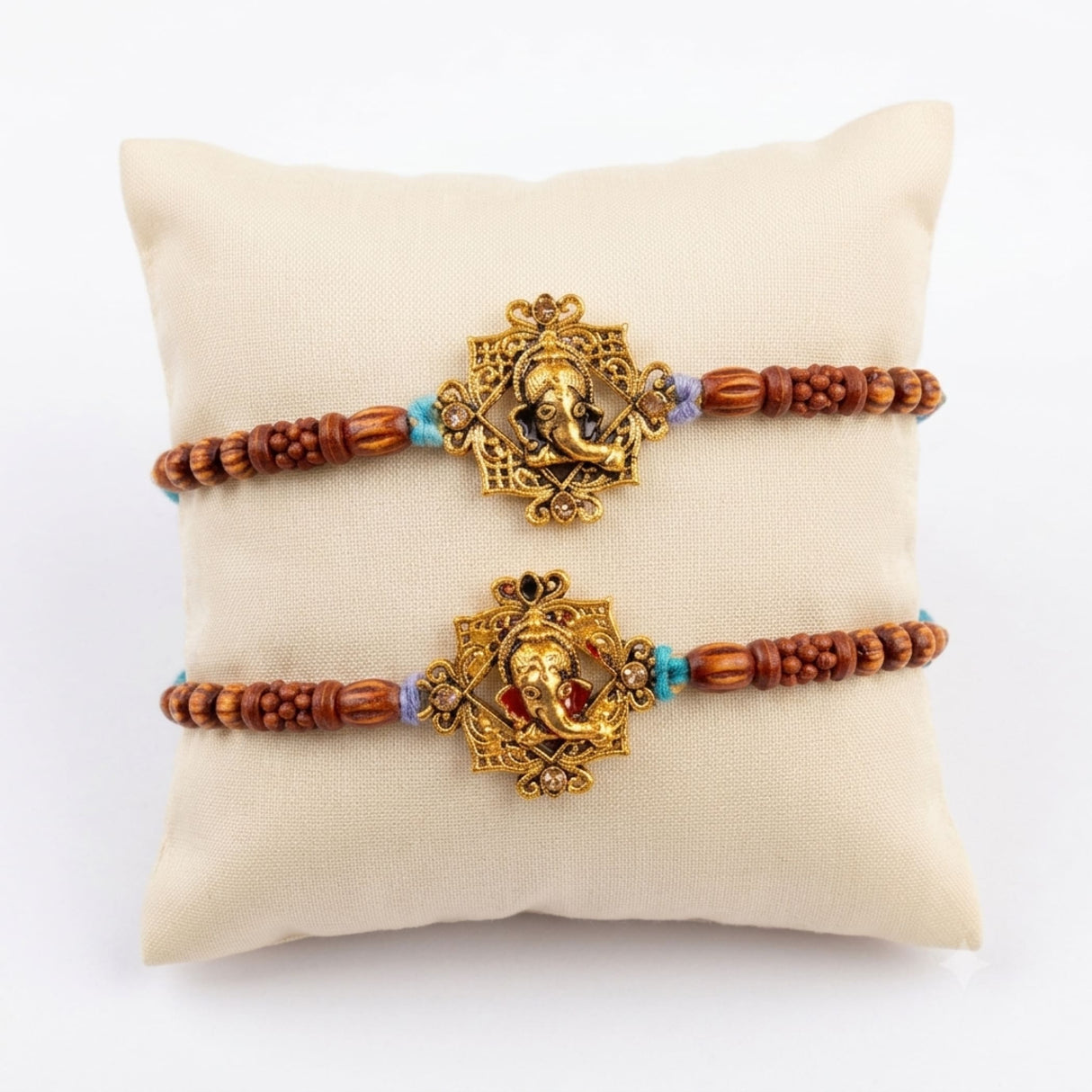 Two golden ganesha designer rakhi bracelets with ornate stone centerpiece and brown wooden beads for raksha bandhan