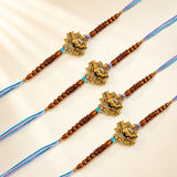 Designer Ganesha rakhi bracelets featuring golden elephant pendants with wooden beads on blue and purple threads for Raksha Bandhan
