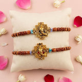 Designer ganesha-themed rakhi with golden finish wooden beads and turquoise accents for raksha bandhan gift