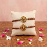Designer ganesha rakhi with golden ganesha centerpiece wooden beads and turquoise accents for raksha bandhan celebration