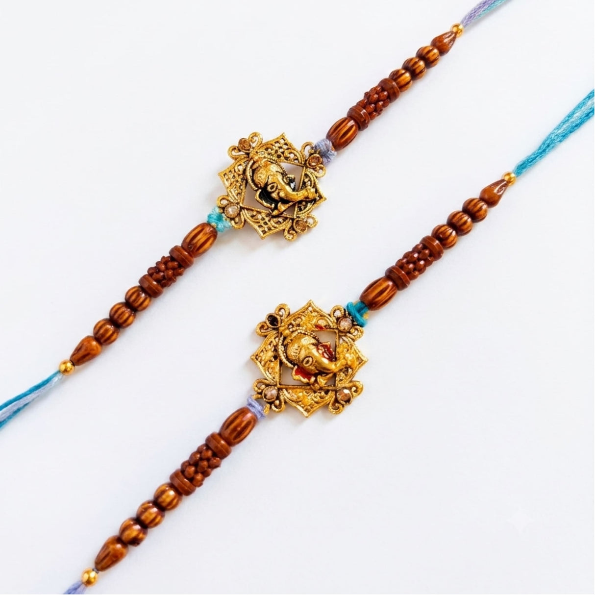 Designer ganesha rakhi with golden elephant charms on wooden beads and blue purple cords for raksha bandhan gift