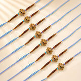 Designer ganesha rakhi with golden ganesha charm, brown wooden beads, turquoise accents on blue threads for raksha bandhan