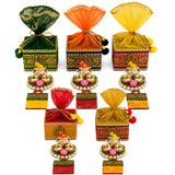 Colorful ornate ganesha gift hamper with gold-trimmed sheer organza tops and decorative ganesha figurines on stands