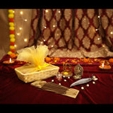 Bamboo Ganesha gift hamper with yellow ribbon, tissue paper, toran, incense holder, and diya