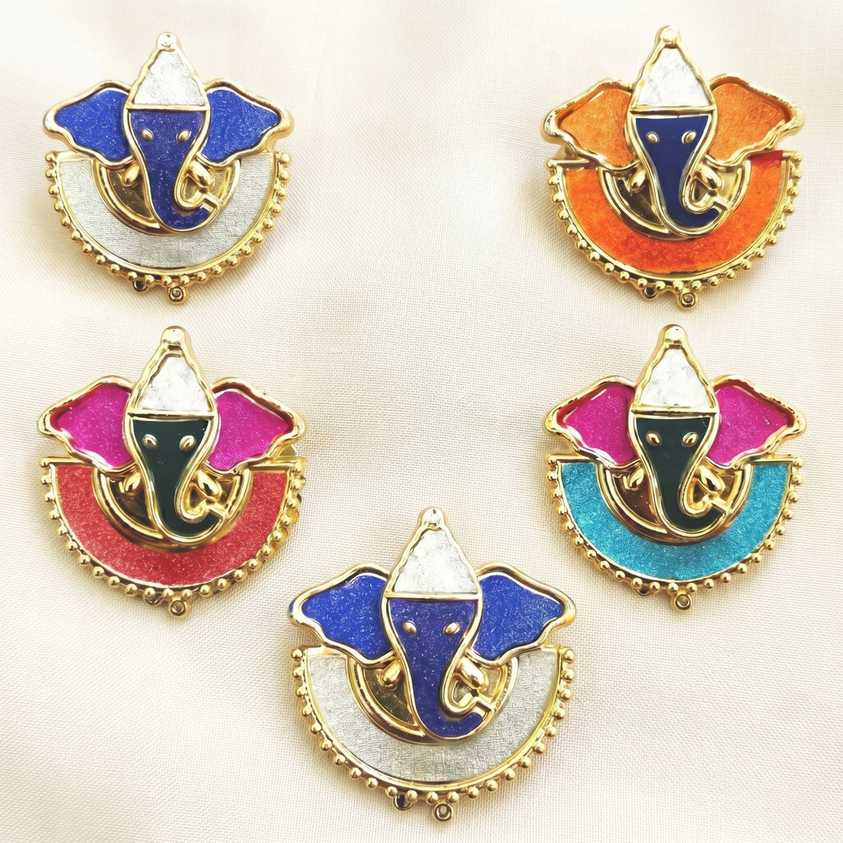 Colorful enamel ganesha pendant charms with gold-tone metal frames and beaded edges for indian festival favors