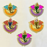Colorful glittery ganesha shaped haldi kumkum holders with gold metal frames and patterned hats for indian festivals