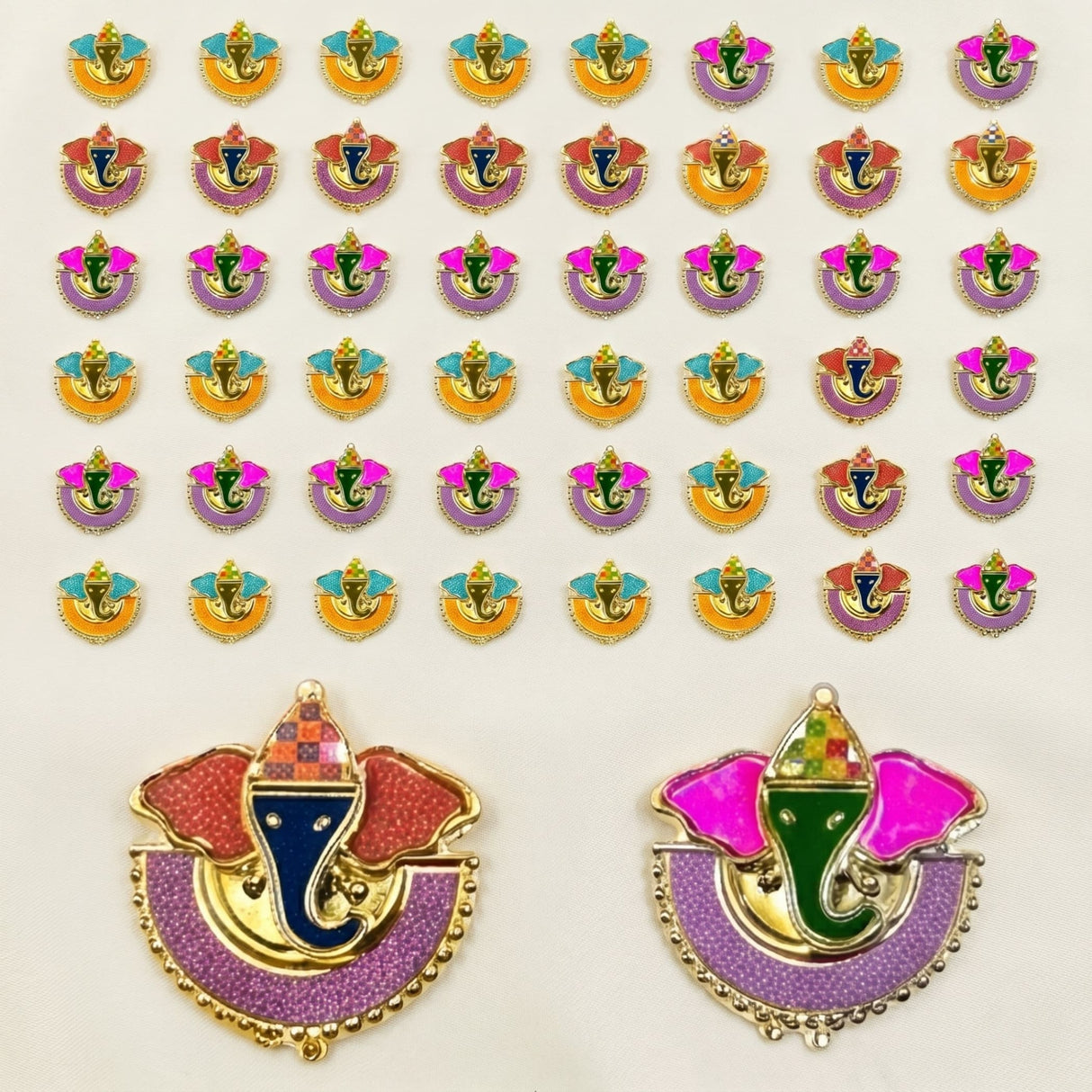 Colorful gold-trimmed ganesha-themed enamel decorative pins in pink purple orange and blue for diwali pooja gifts
