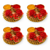 Golden ornamental haldi kumkum thali tray with red and yellow powders, decorative roses, and a small elephant figurine for pooja