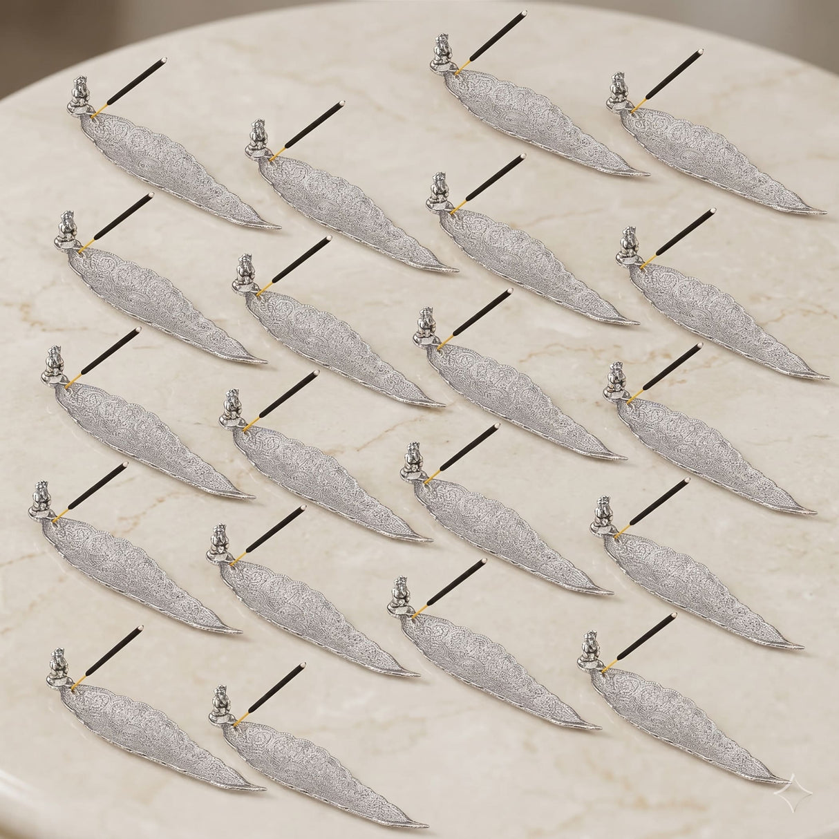 Silver leaf-shaped stick incense holder with intricate filigree and turquoise gemstone accents for home use