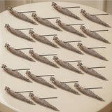 Silver leaf incense holder with intricate filigree designs and small red gemstone accents for home use