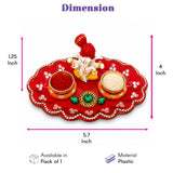 Red plastic ganesha haldi kumkum holder thali with scalloped edges, rhinestones, and green gemstones for pooja gifts