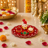 Red ornate ganesha haldi kumkum holder thali with rhinestones, green gemstone, bowls of red powder and rice, ideal for pooja gifts