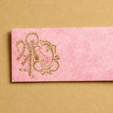 Pink textured money envelope with gold foil embossed ganesha design for indian wedding and cash gift holder