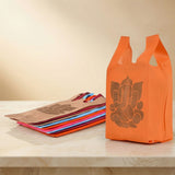 Bright orange non woven reusable shopping bag with brown ganesha print for Indian weddings puja and housewarming