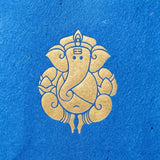 Ganesha paper carry bag featuring golden Ganesha emblem on textured blue paper for wedding and Ganesh Chaturthi gifts