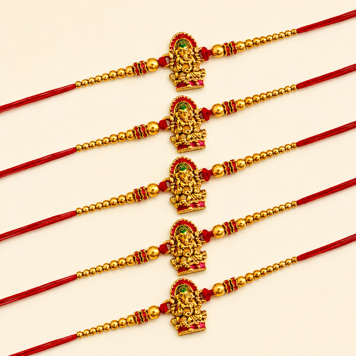 Five handcrafted golden ganesha rakhi bracelets with red threads and beads for brother and bhabhi raksha bandhan gift