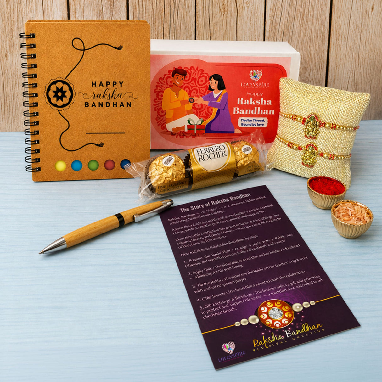 Designer Ganesha Rakhi Gift Hamper for Brother & Bhabhi - Includes 2 Rakhi Bracelets, Chocolates, Diary, Pen, Roli Chawal & Gift Box, Symbolizing Good Luck & Growth