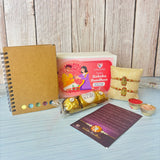 Designer Ganesha Rakhi Gift Hamper for Brother & Bhabhi - Includes 2 Rakhi Bracelets, Chocolates, Diary, Pen, Roli Chawal & Gift Box, Symbolizing Good Luck & Growth