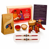 Red and gold embroidered elephant-shaped candle holder with intricate detailing from designer ganesha rakhi gift hamper