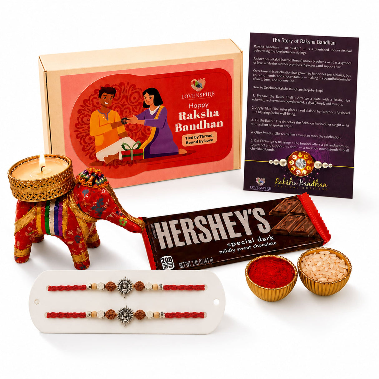 Designer ganesha rakhi gift hamper featuring a red and gold ornate elephant-shaped candle holder for brother and bhabhi