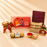 Red and gold decorative elephant-shaped candle holder with intricate patterns in designer ganesha rakhi gift hamper