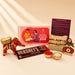 Designer Ganesha Rakhi gift hamper red and gold elephant-shaped diya with intricate embroidery for brother and bhabhi