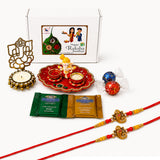 Red and gold ornate ganesha-themed rakhi bracelets from raksha bandhan gift hamper set for bhaiya bhabhi