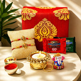 Red and gold patterned brocade gift box with intricate golden embroidery for raksha bandhan hamper for brother and bhabhi