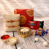Gold-colored ornate elephant figurine with intricate painted patterns in raksha bandhan brocade gift box hamper for brother and bhabhi