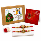 Gold-colored ganesh rakhi with red thread and intricate beadwork in a traditional handmade bracelet set for brother and bhabhi