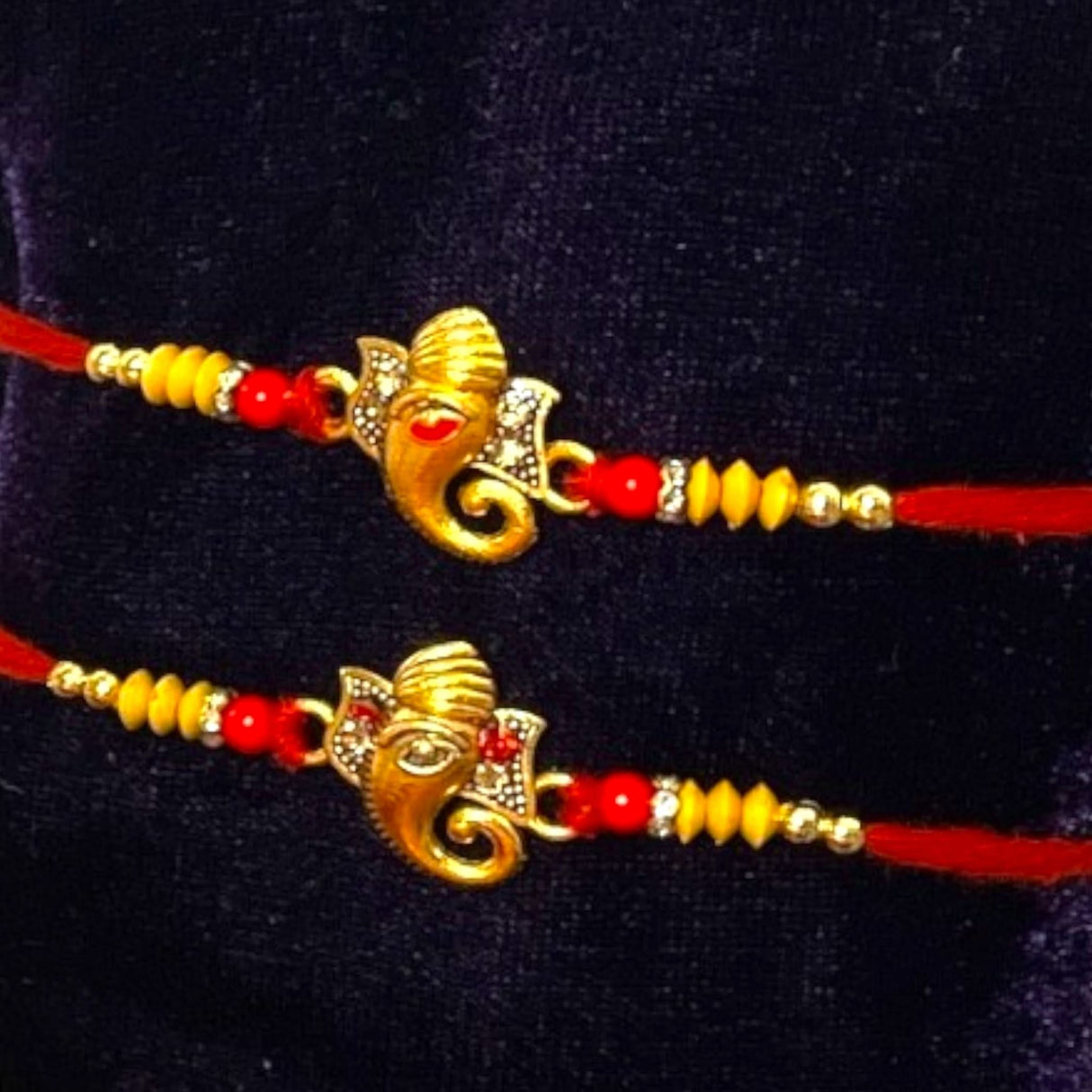 Image of two Ganesha Rakhi bracelets from the Ganesha Rakhi Gift Hamper set