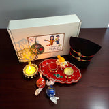 Raksha Bandhan gift set featuring Ganesha Rakhi with traditional Puja plate and accessories