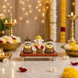 Lord ganesha figurine with golden crown and red attire flanked by riddhi siddhi goddesses in traditional jewelry for pooja and home decor