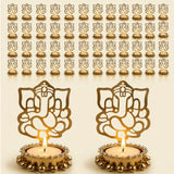 Gold-colored ganesha tea light candle holders with intricate cut-out designs and beaded edges for diwali decor