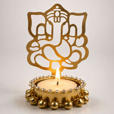 Golden metallic ganesha tea light candle holder with intricate cutout design and beaded embellishments for diwali decor
