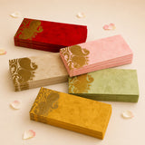 Stacks of colorful decorative dual paisley pattern money envelopes in red pink beige green and yellow for indian weddings and gifts