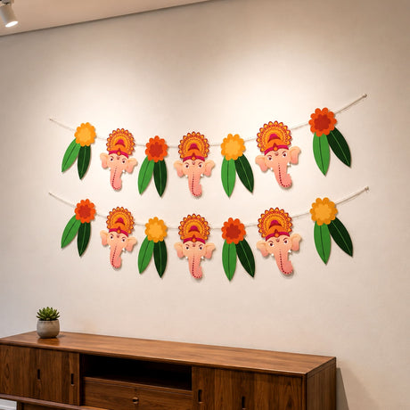 A two-row garland featuring pink ganesha heads with orange floral crowns and green leaves for ganesh chathurti decor